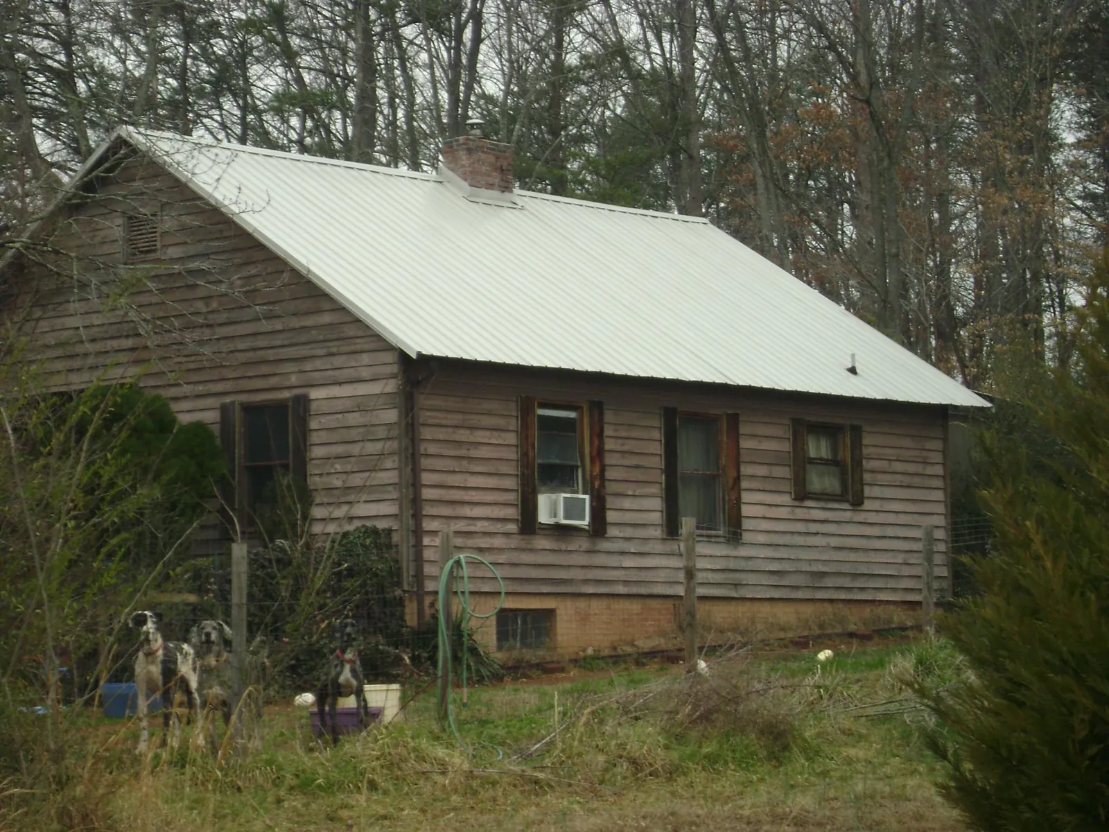 White metal roof on an old wood sided farmhouse, from a Asphalt Shingle Roof Repair job in Leesburg